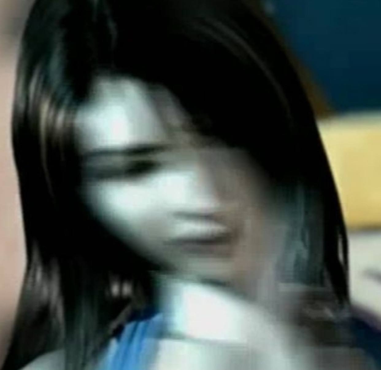 A blurred person with dark hair is present; the face is not distinctly visible due to motion blur or a similar visual effect causing smearing across the image. The background is too obscure to derive any detailed information.