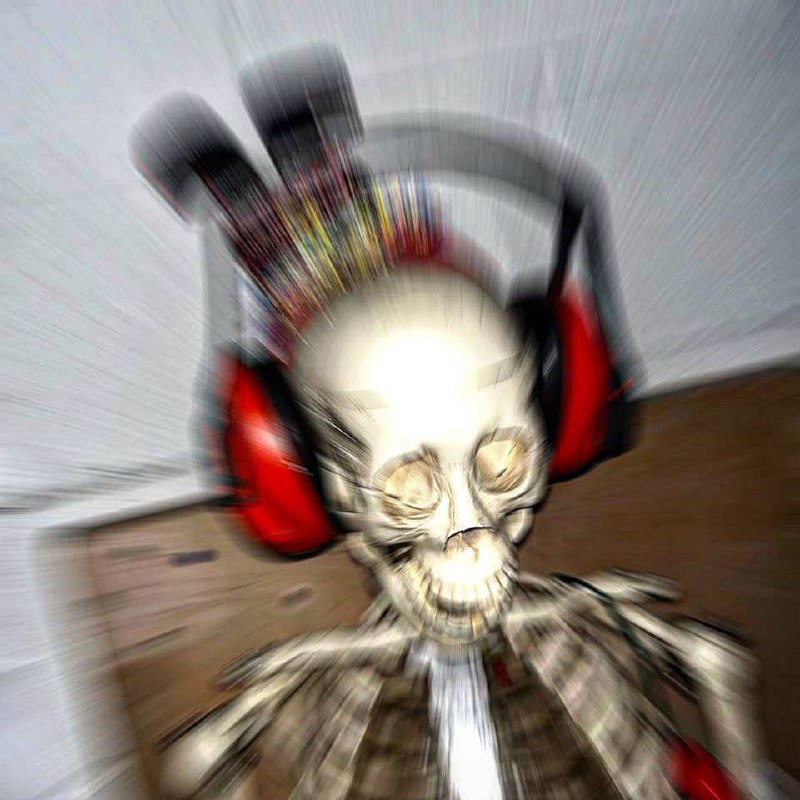 There appears to be a digitally altered, blurry, and visually noisy representation of a skull wearing over-ear headphones. The image is radiating outwards with lines suggesting movement or motion, creating a somewhat unsettling and fragmented effect. It seems as though motion blur or a zoom burst photography technique might have been used to create this dynamic distortion.