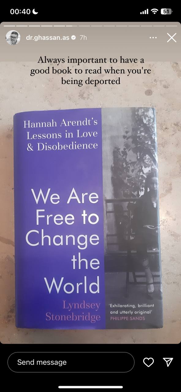 A screenshot of a social media story featuring a book with a purple cover titled "We Are Free to Change the World" by Lyndsey Stonebridge, which references Hannah Arendt's "Lessons in Love & Disobedience". There is a caption on the story that says, "Always important to have a good book to read when you're being deported". The image also includes the interface elements of the social media platform like the account username, time, wifi signal, battery level, and ways to interact with the story (message sending and like options).