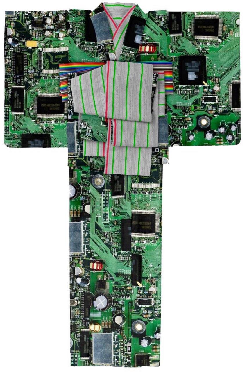 An artistic collage resembling clothing, particularly a robe or perhaps a traditional eastern garment (a kimono or similar), is created from a patchwork of computer circuitry boards.